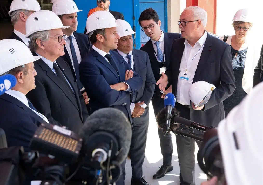 Emmanuel Macron, President of France (in the center) listens to Jean-Marc Chery, STMicroelectronics CEO talks. Thierry Breton, EU Commissioner for Internal Market stands next to Macron.
